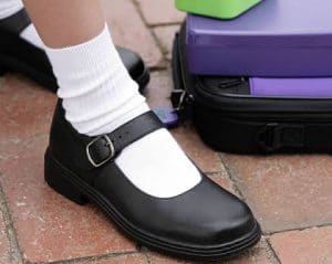 school shoe next to purple case