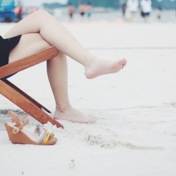 lady sitting on sandy beach