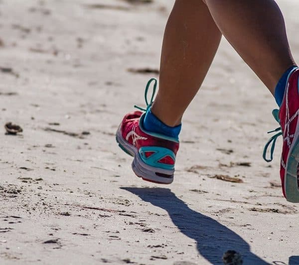 Beach running in ASICS training shoes