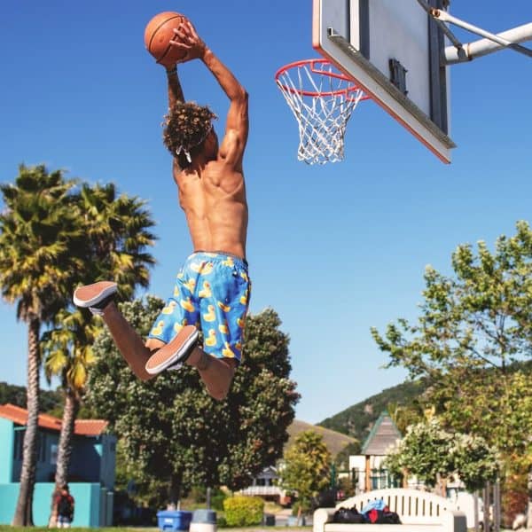 Teenager slam dunking a basketball