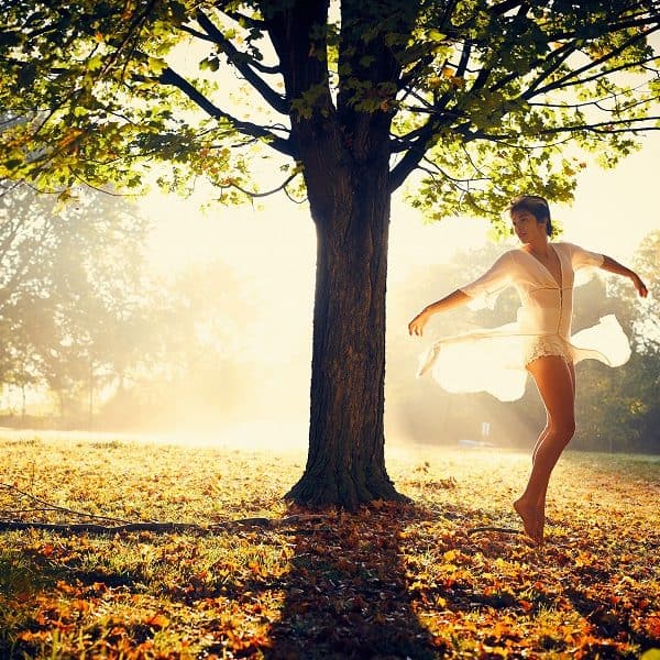 Dancer dancing in the park near tree
