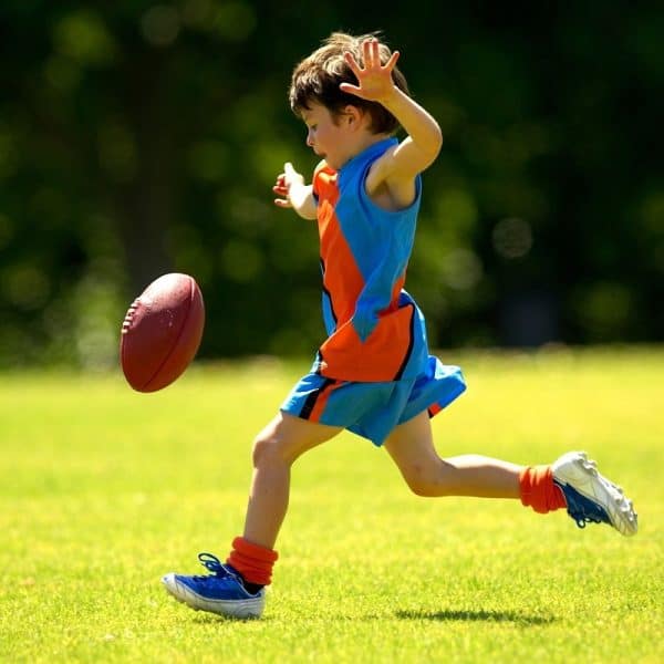 Child kicking a football