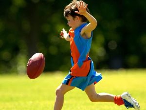 Child kicking a football