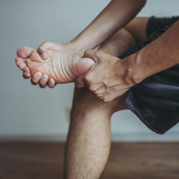Person applying self massage and mobilisation to the foot