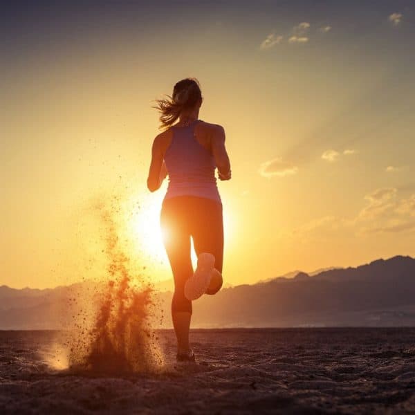 Lady running towards sunset