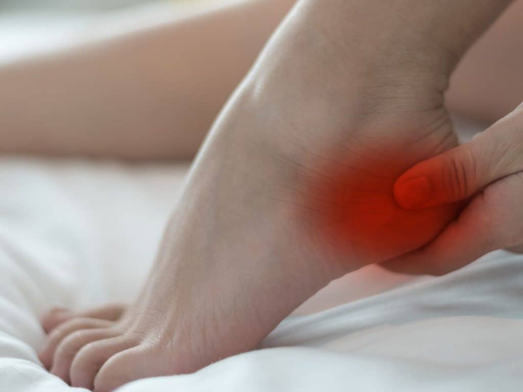 An image of a person holding a sore heel
