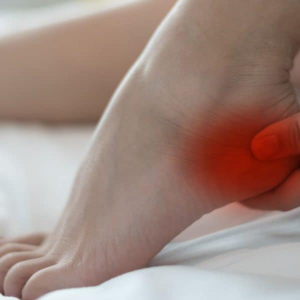 An image of a person holding a sore heel