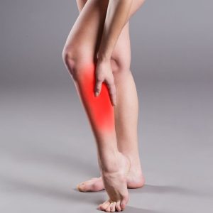 Image of lady holding a red and inflamed leg