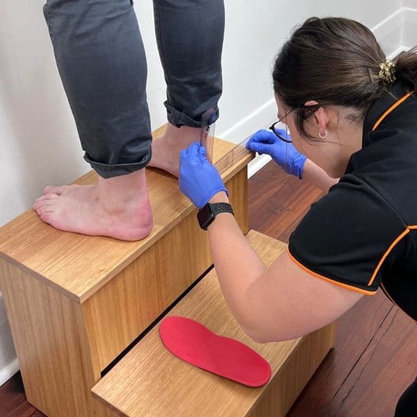 Adelaide Podiatrist, Tess Clisby, checking orthotic measurements