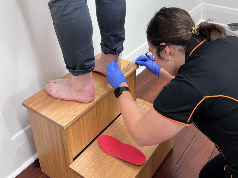 Adelaide Podiatrist, Tess Clisby, checking orthotic measurements