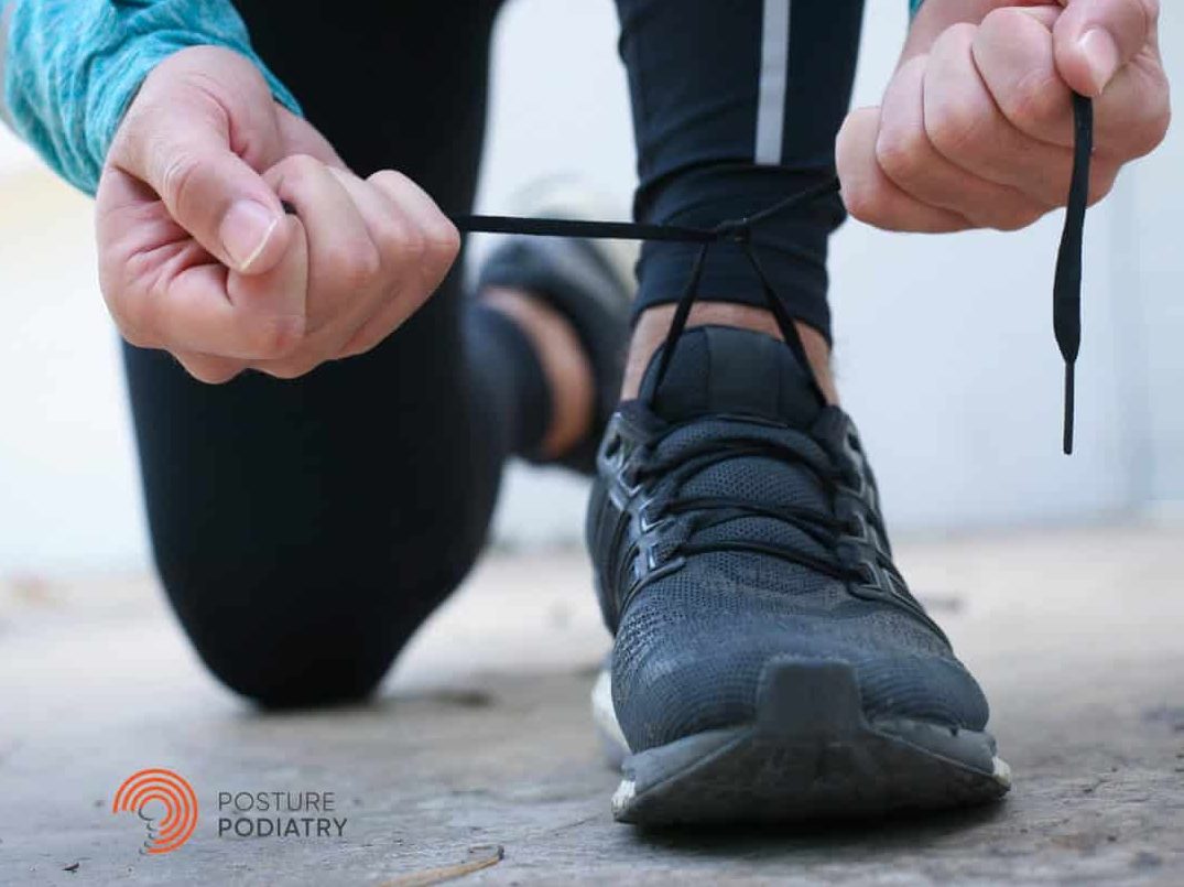 Person lacing up running shoes