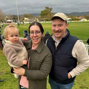 Tess Clisby with daughter and husband at the footy